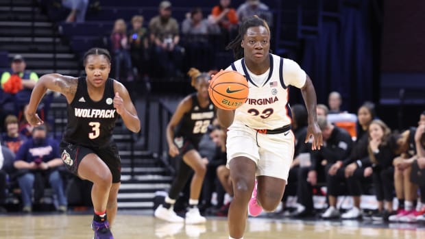 Alexia Smith dribbles the ball up the floor during the Virginia women's basketball game against NC State at John Paul Jones Arena.
